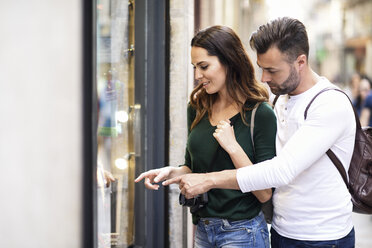 Couple looking at shop window in the city - JSMF00331