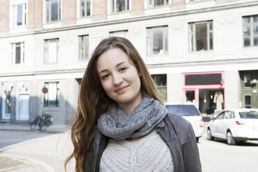 Portrait of teenage girl on city street - CUF34843