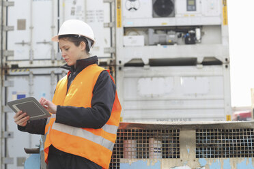 Female dockworker using monitor - CUF34988