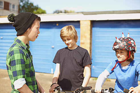 Three boys talking near garages - CUF35156