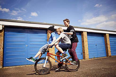 Boy giving two friends a ride on bike - CUF35162