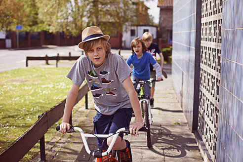 Boys cycling on pavement - CUF35165