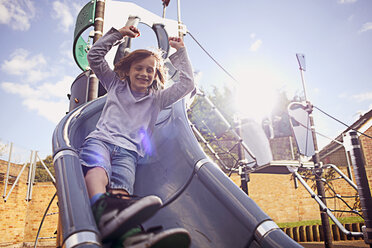 Boy coming down slide - CUF35168