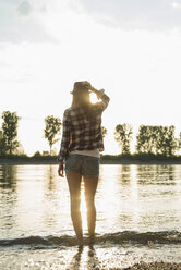 Young woman standing by lake - CUF35200