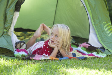 Portrait of girl daydreaming in garden tent - CUF35275