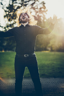 Heavy metal fan headbanging in a park - JSCF00114