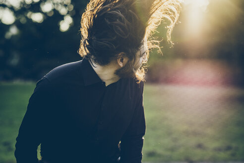 Heavy metal fan headbanging in a park - JSCF00116