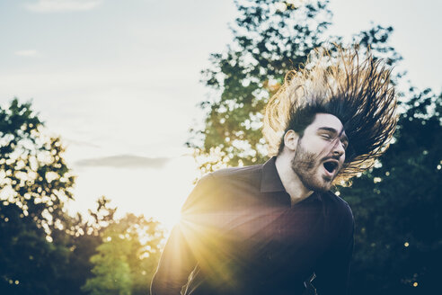 Heavy metal fan headbanging in a park - JSCF00117