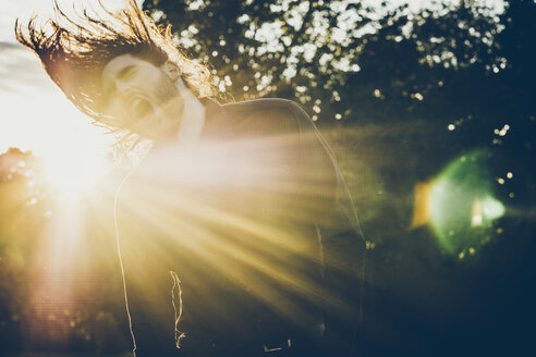 Heavy metal fan headbanging in a park - JSCF00118