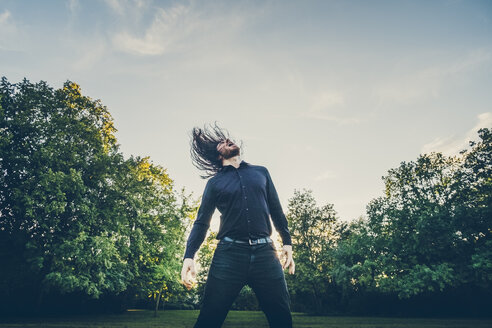 Heavy metal fan headbanging in a park - JSCF00121