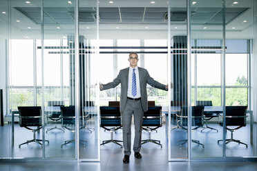 Businessman at entrance to meeting room - CUF36120