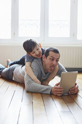 Father and son self-photographing with digital tablet - CUF36152