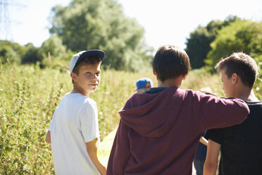 Portrait of boy wearing cap with friends - CUF36386