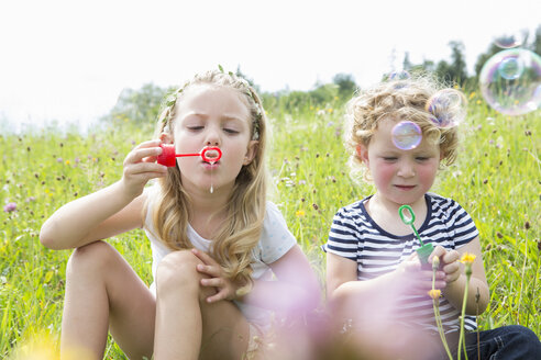 Two girls blowing bubbles - CUF36402