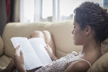 Young woman reading book - CUF36434