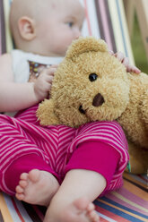 Baby girl holding teddy bear - CUF36776