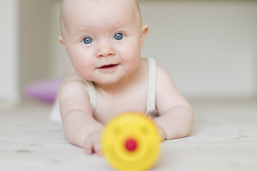 Baby girl with toy in foreground - CUF36780