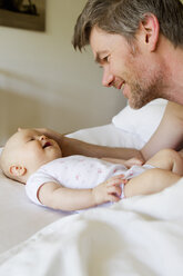 Father and baby daughter on bed - CUF36787