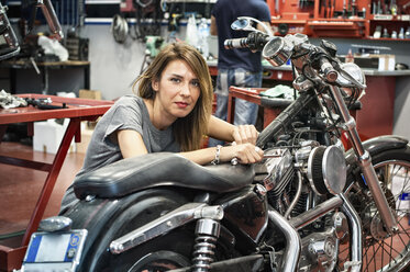 Portrait of female mechanic in motorcycle workshop - CUF36847