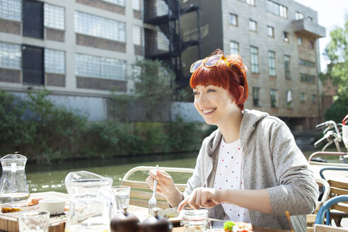 Frau beim Mittagessen am Kanal, East London, UK - CUF36860