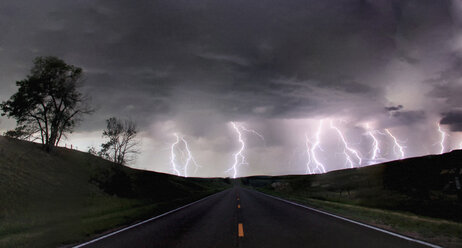 A composite image from 5 images of cloud-to-ground lightening bolts at the end of a rural road, Lexington, Nebraska, USA - CUF36957