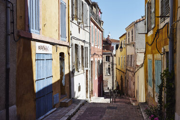 Colorful house exteriors along alleyway, Marseille, France - CUF36959