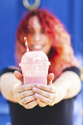 Woman's hands holding plastic cup of smoothie - WPEF00485