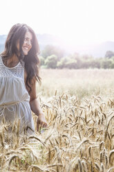 Young woman in wheat field - CUF37357