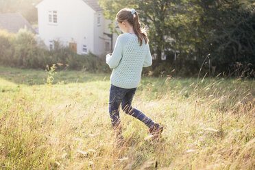 Girl walking through field - CUF37406