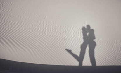 Sand shadow of cute couple embracing, Cagliari, Sardinia, Italy - CUF37584