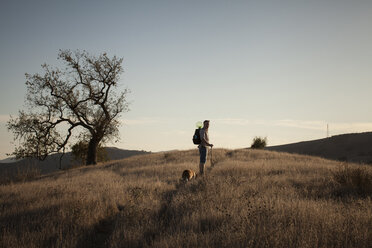 Mature man and his basset hound walking in Santa Monica Mountains, California, USA - ISF14601