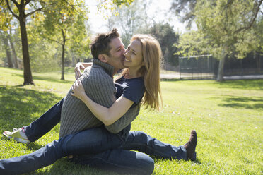 Couple hugging and kissing on grass - ISF14677