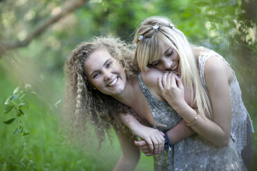 Two teenage girls having fun in woodland - ISF14721