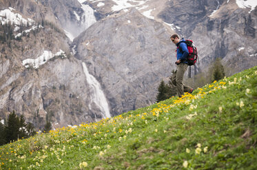 Man hiking near Engstligen falls, Adelboden, Bernese Oberland, Switzerland - ISF14813