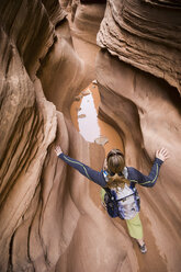 Woman hiking Little Wildhorse Canyon in the San Rafael Swell, Utah, USA - ISF14869
