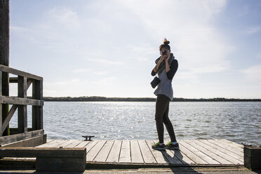 Young woman photographing with digital camera, Richmond, British Columbia, Canada - ISF15000