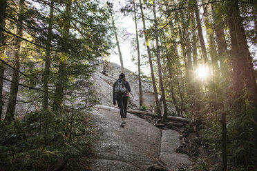 Junge Frau geht durch den Wald, Squamish, British Columbia, Kanada - ISF15017