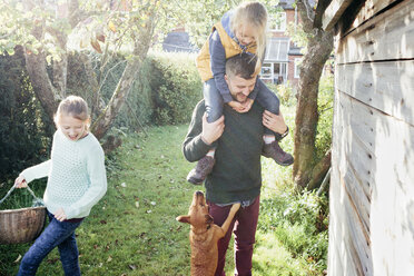 Vater mit Tochter auf den Schultern im Garten - CUF37918