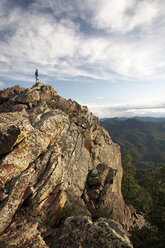 Man standing on rock formation, Boulder, Colorado, USA - ISF15228