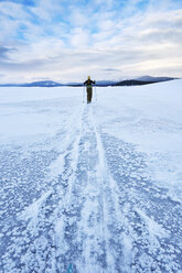 Mid adult woman skiing across vast landscape, Colter Bay, Wyoming, USA - ISF15231