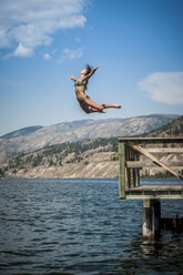 Junge Frau springt in den Okanagan-See, Naramata, British Columbia, Kanada - ISF15256