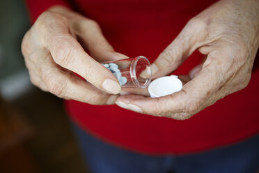 Close up of 82 year old senior woman's hand with pill bottle - ISF15267