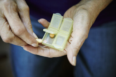 Close up of 82 year old senior woman's hand with pill box - ISF15268