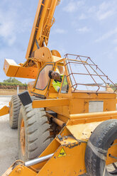Construction worker operating crane - ZEF15746