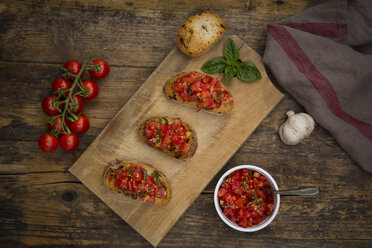 Bruschetta with tomato and basil on wooden board - LVF07177