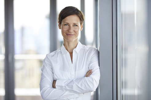 Portrait of smiling businesswoman in office - RBF06354