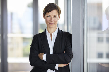 Portrait of smiling businesswoman in office - RBF06359