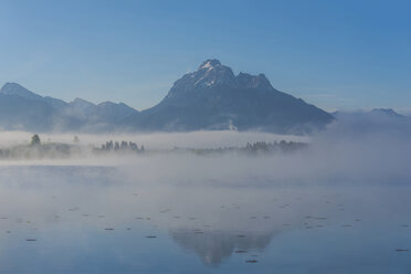 Germany, Bavaria, Allgaeu, Ammergau Alos, Mountains at Lake Hopfensee and fog - WGF01202