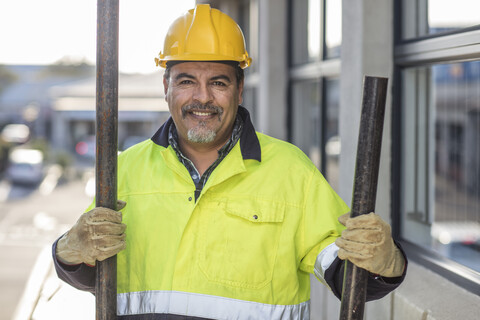 South Africa, Cape Town, Builder holding pipes stock photo