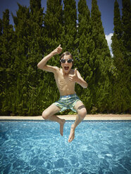 Boy jumping into swimming pool, Majorca, Spain - CUF38102